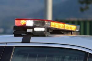 Emergency lights flash on top of a police car. (Ben Hohenstatt / Juneau Empire file photo)