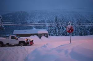 A truck with a snowplow drives along Douglas Highway on Dec. 31, 2025. (Mari Kanagy / Juneau Empire)