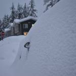 A car engulfed in snow has only its side mirrors exposed Dec. 31, 2025. (Mari Kanagy / Juneau Empire)