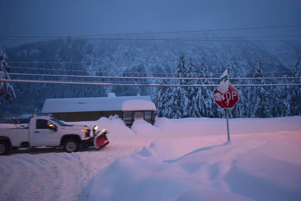 A truck with a snowplow drives along Douglas Highway on Dec. 31, 2025. (Mari Kanagy / Juneau Empire)