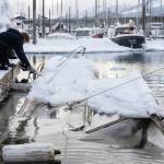 Salvage captain Trevin Carlile, left, and diver Phil Sellick at Melino’s Marine Service re-float a sunken boat in Harris harbor on Jan. 8, 2026. Record-breaking snow at the beginning of the month caused at least eight boats to sink in Harris, Douglas and Aurora harbors, resulting in oil spills. (Chloe Anderson for the Juneau Empire)