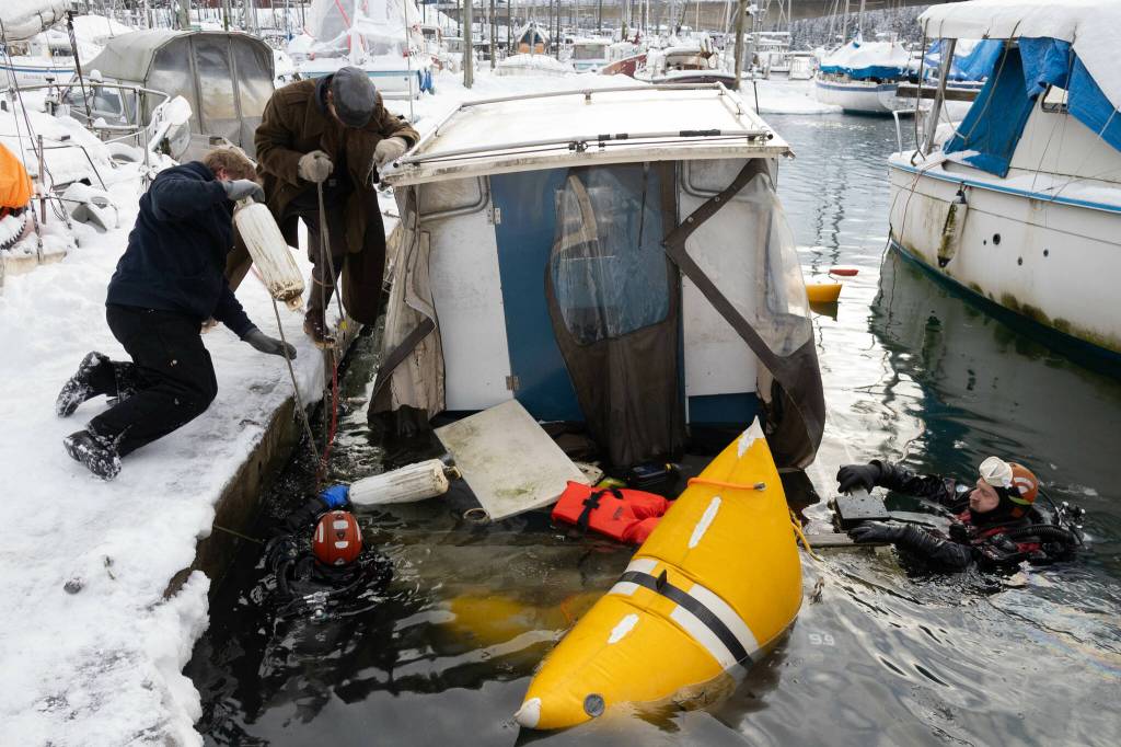 Crew and divers at Melinos Marine Service re-float a sunken boat in Harris harbor on Jan. 8, 2026. (Chloe Anderson for the Juneau Empire)