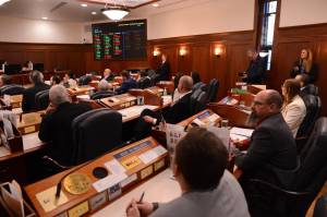 Members of the Alaska House of Representatives and Alaska Senate watch as the final vote on Gov. Mike Dunleavys veto of Senate Bill 113 is displayed on the voting board in the House on Thursday, Jan. 22, 2026. (Photo by James Brooks/Alaska Beacon)