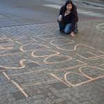 Macelle Joseph, a member of the Juneau-Douglas High School: Yadaa.at Kalé chapter of Alaska Youth for Environmental Action, writes Its Native blood in the soil, not your oil outside the Alaska State Capitol building on Jan. 24, 2026. Dozens of Juneauites participated in the student-led protest against the LNG pipeline. (Chloe Anderson / Juneau Empire)