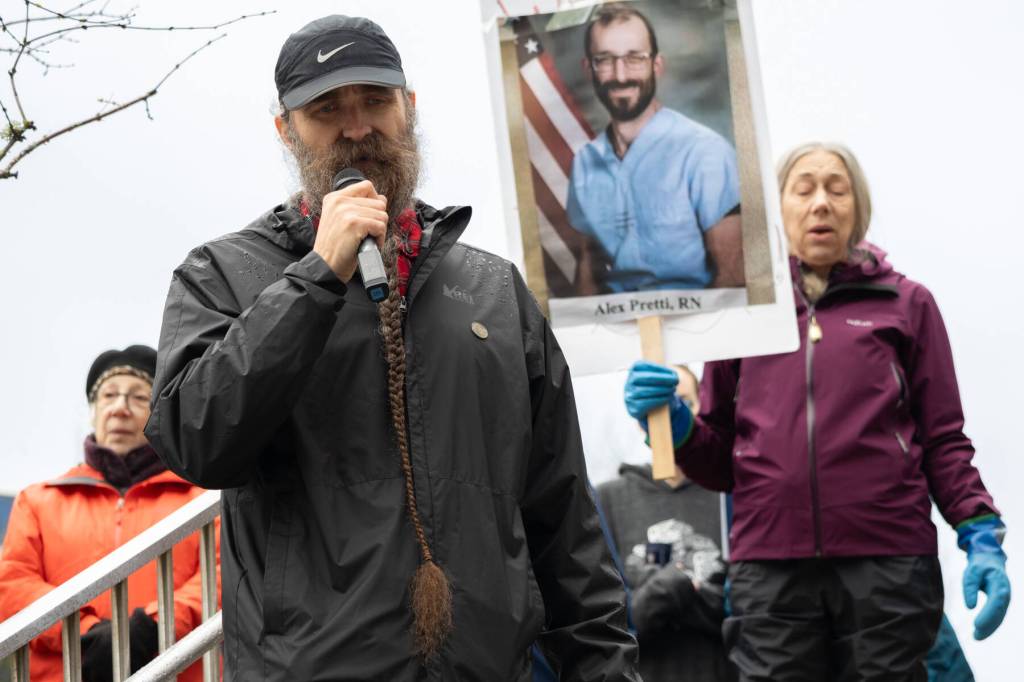 Eric Antrim leads a crowd of more than 200 people at the Dimond Courthouse plaza on Jan. 29, 2026 in a song he wrote after federal agents killed 37-year-old Alex Pretti in Minneapolis. (Chloe Anderson/Juneau Empire)