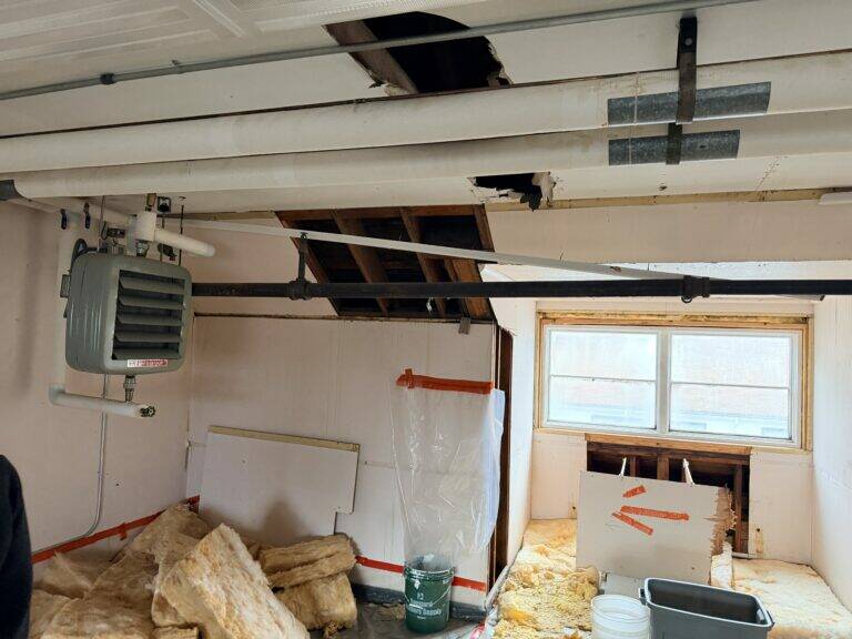 Photo courtesy of the Senate Finance Committee
Buckets catch water from a leaky roof in the attic of a Mt. Edgecumbe High School girls dormitory, seen by legislators on a legislators visit on Feb. 6, 2026.