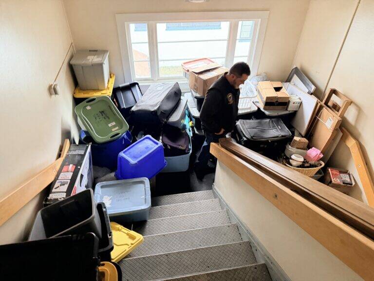 Photo courtesy of the Senate Finance Committee
Storage containers and suitcases are stacked in a stairwell of the Mt. Edgecumbe girls dormitory as the attic is leaking, seen on a legislators visit on Feb. 6, 2026