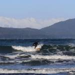 Surfer catches wave at Lena Cove. (Photo by Atticus Hempel/Juneau Empire)