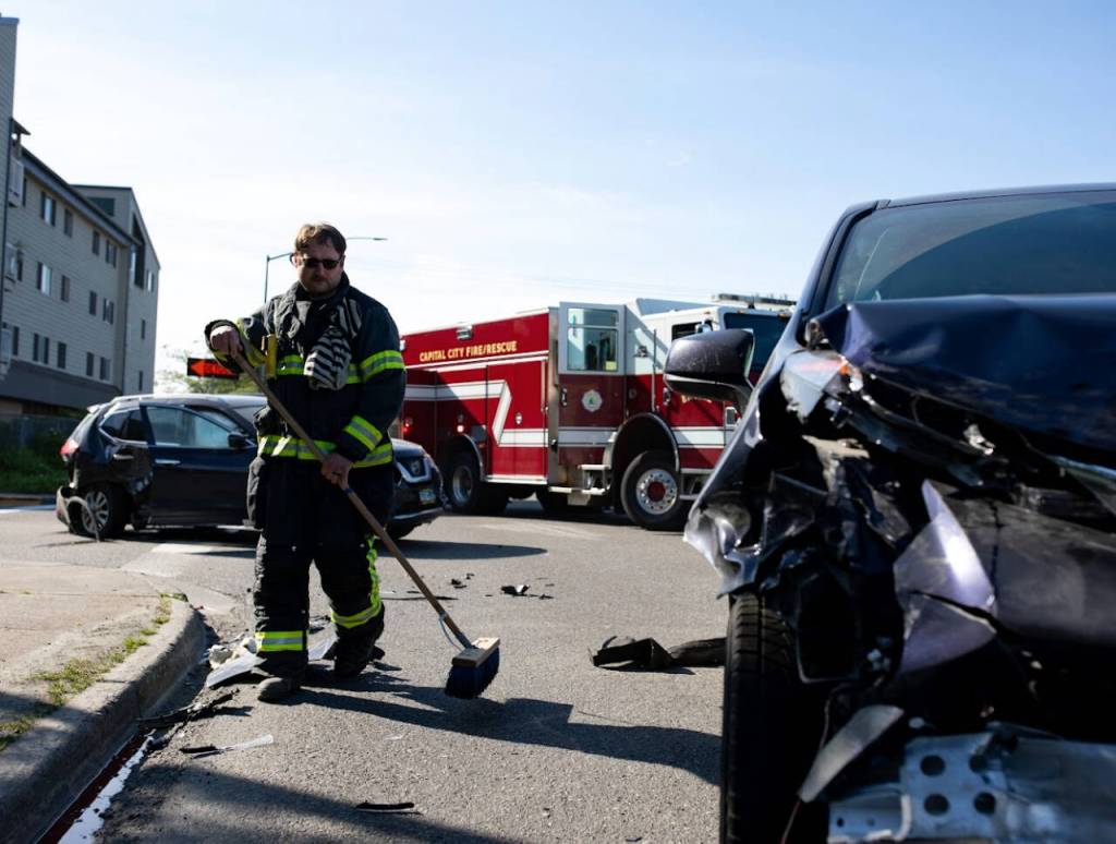 Engineer Logan Balstad cleaning up after a car crash.
