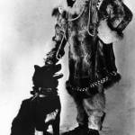 Serum Run musher Gunnar Kaasen poses with Balto, a leader on his mushing team. Alaska State Library Portrait File