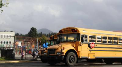 School buses park outside the playground of Xóots Elementary School in Sitka on Oct. 6, 2025 (Photo by Corinne Smith/Alaska Beacon)
