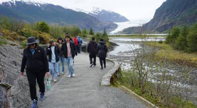 Photo by Yereth Rosen/Alaska Beacon 
Tourists walk to and from a viewpoint at the Mendenhall Glacier visitor center on May 14, 2025. The visitor center in the Tongass National Forest is a top tourist destination.