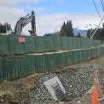Crews fortify Hesco barriers along the Mendenhall River on Riverside Dr. to prepare for glacial outburst flooding on Apr. 25, 2026. (Photo by Corinne Smith/Alaska Beacon)