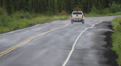 UAF photo by Sam Bishop 
A pickup negotiates bumps on a recently patched stretch of Ballaine Road in Goldstream Valley north of Fairbanks.