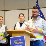 Ryan OShaughnessy, emergency manager for the City and Borough of Juneau, Ginny Nadolny, commander of US Coast Guard Southeast Sector (center) and Sabrina Grubitz, public safety manager for Central Council of Tlingit and Haida Indian Tribes of Alaska (left) speak at a news conference ahead of the glacial outburst flood in Juneau on Aug 12, 2026. (Photo by Corinne Smith/Alaska Beacon)