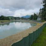 Sandbag barriers newly constructed this year in the lower part of the Mendenhall River below Brotherhood Bridge are seen from Meadow Lane in Juneau on Aug 8, 2026. (Photo by Corinne Smith/Alaska Beacon)